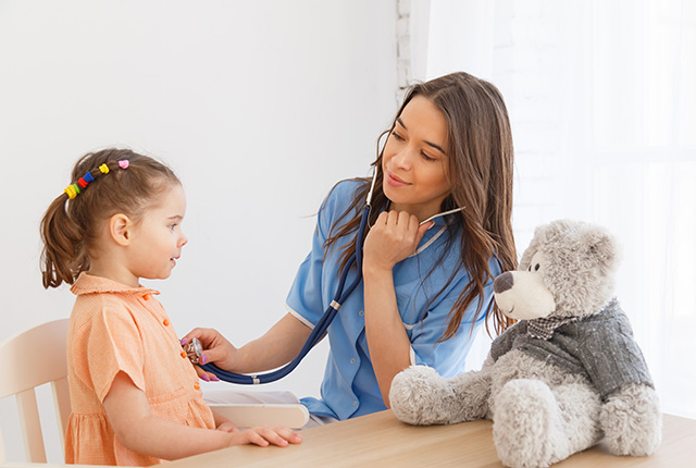 woman listening to girl's pulse